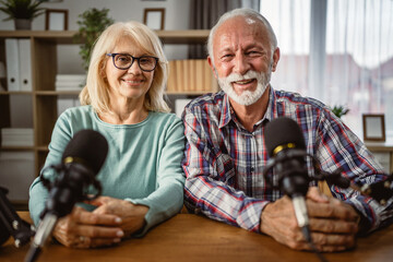 Portrait of senior man host and senior woman guest in the podcast