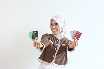 Smiling Woman in Hijab Shows Credit Cards, Online Shopping, E-commerce, Banking, Finance, Muslim Woman, Happy Customer, Retail, Payment, Transaction