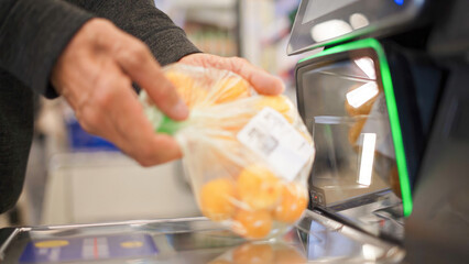 Customer scans food products at selfservice kiosk in store