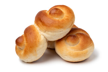Fresh homemade white buns of bread in a special shape isolated on white background close up