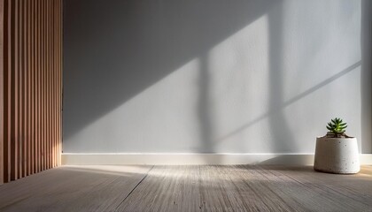 Empty Light Gray Wall Mockup in Minimalist Interior with Single Stool with a Small Succulent in a Concrete Pot. Natural Daylight From a Window. Promotion Background.