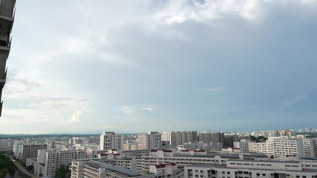 Time lapse video of urban building with white and rain clouds above Singapore HDB estate
