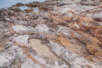 Close-up view of rugged rocks showcasing detailed natural textures and formations in vibrant hues.