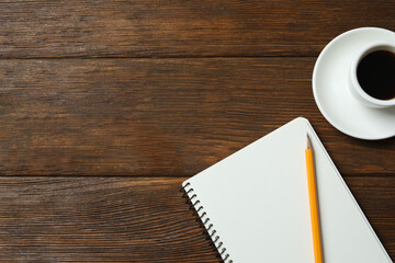 Workplace with notebook, pencil and coffee cup, top view