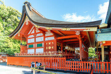 Two Japanese boys in front of a building on the grounds of the Fushimi Inari Shinto Shrine and the sacred grove of Mount Inari in Kyoto, Japan