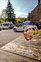 glass of wine over background with retro cars, traveling in the united kingdom concept