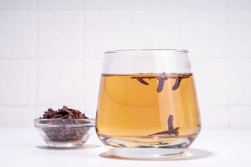 Clove Water or Tea, organic infused drink. Ayurvedic, antiseptic, anti-inflammatory and antioxidant drink, brewed dry clove remedy in glass
