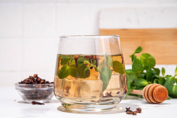 Clove mint julep summer infused drink, clove water or tea.  Ayurvedic, antiseptic, anti-inflammatory and antioxidant drink, brewed dry clove remedy in glass