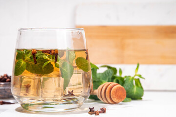 Clove mint julep summer infused drink, clove water or tea.  Ayurvedic, antiseptic, anti-inflammatory and antioxidant drink, brewed dry clove remedy in glass