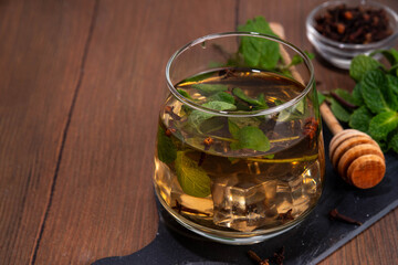 Clove mint julep summer infused drink, clove water or tea.  Ayurvedic, antiseptic, anti-inflammatory and antioxidant drink, brewed dry clove remedy in glass
