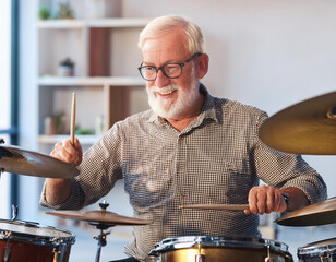 senior man learning to play the drums at her home