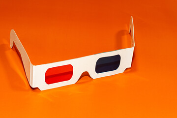 3D glasses on orange background. 