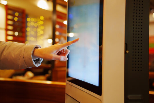 making an order on touch screen menu in cafe. convenience, ease of choice of dishes and payment in modern quick service restaurants