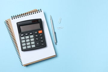 Bookkeepers work place concept. Top above overhead view photo of office accessories calculator, notebook on color backdrop with blank empty space