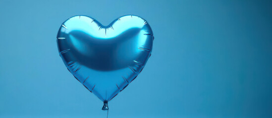 Shiny blue heart balloon floating against a blue background