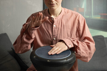 Female musician playing djembe