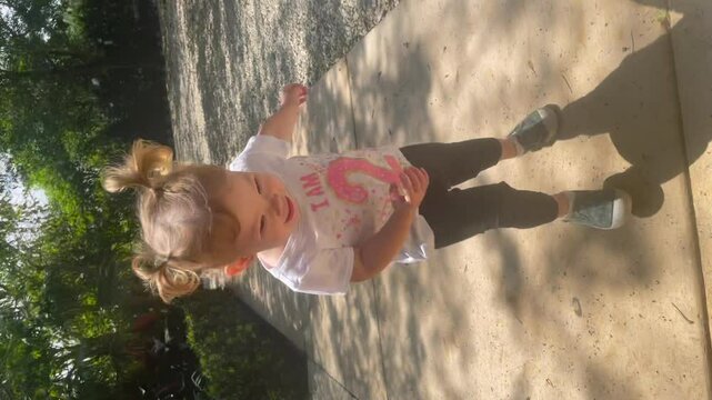 Cute Caucasian little girl running happily. 2 year old girl running and laughing. Happy childhood concept. 