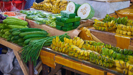 Bunch of green bananas for sale at a street food market.