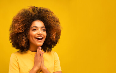 Young African Woman Surprised Smiling at Camera on Yellow Background.