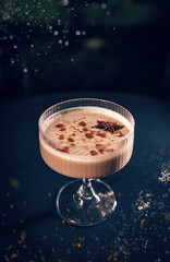 Festive eggnog cocktail is garnished with cinnamon