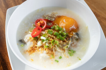 Rice congee with soft-boiled egg flavor with pickled chili vinegar and ground dried chilies