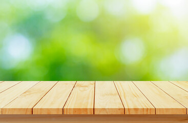 Wood floor with blurred trees of nature park background and summer season, product display montage