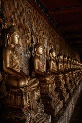 Close-up of sitting golden Buddha statues