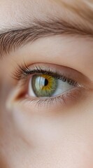 Obraz premium Close-up of a person's hazel eye looking to the side.