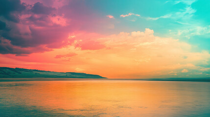 Fototapeta premium A serene sunset over calm waters, blending vibrant colors in the sky and reflection on the surface.