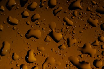 Water drops on color glass surface, macro view