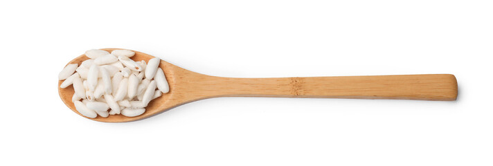 Puffed rice in spoon isolated on white, top view