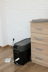 Modern portable power station, charging attached devices indoors