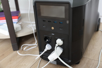 Modern portable power station on floor indoors, closeup