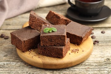 Delicious chocolate puffed rice bars and mint on wooden table, closeup