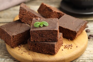 Delicious chocolate puffed rice bars and mint on wooden table, closeup