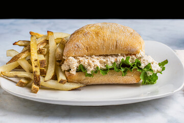 chicken salad  on a ciabatta roll with fries