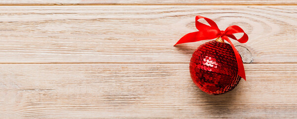 Christmas ball on colored background. decoration bauble with ribbon bow with copy space