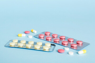 Blister package with Vitamin on color background. Medicine pills on a light background. Medicines...