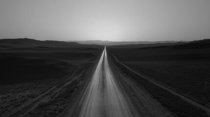 A desolate, straight highway cuts through the flat landscape, disappearing into the distance.