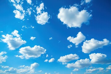 Obraz premium Scattered white clouds in a vivid blue sky on a sunny day