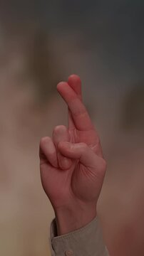 Hope and Anticipation A Hand with Fingers Crossed, Symbolizing Optimism and Desire for the Future