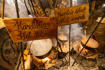 Riga, Latvia A cauldron of hot wine and hot apple drink cooking over an open flame at the annual...