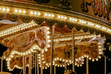 Cheshire, United Kingdom, 2024: Close up of carrousel ride at fair, orange tint, vintage look, with...