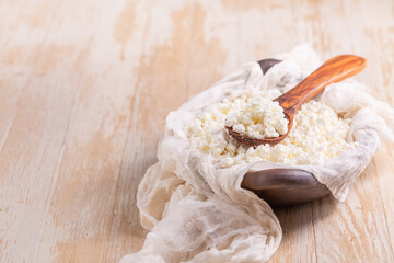 Curd cheese in a bowl on kitchen table
