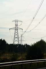 The photo shows a power line against a gray sky