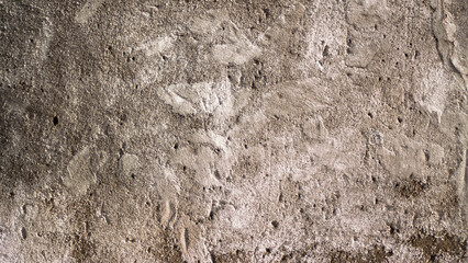 The photo shows an old brown concrete wall