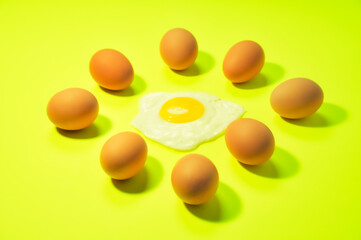 One fried egg in the center of brown eggs