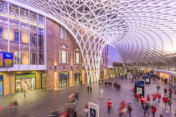 Unique architectural design of a busy train station atrium in Central London during evening rush hour