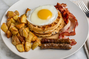 fried eggs on stack waffles   with home fries