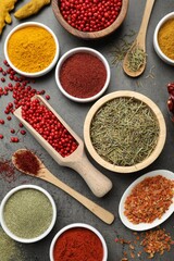 Different aromatic spices on grey table, flat lay